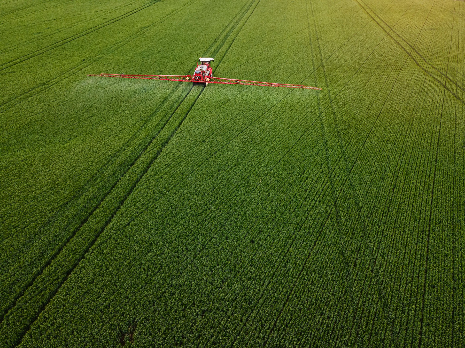 AI Crop Sprayer in Green Agricultural Field, Aerial View.